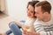 Positive couple resting on the floor