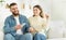 Positive couple sharing headphones and enjoying favourite song