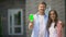 Positive couple showing smartphone with green screen, flat booking app online