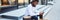 positive dark skinned man in stylish hat resting after shopping time