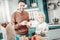 Positive delighted daddy cooking dinner with son