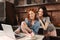 Positive delighted young females posing in the kitchen