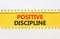 Positive discipline symbol. Concept words Positive discipline on beautiful yellow paper. Beautiful white table white background.