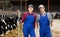 Positive diverse cow farm workers squatting in cowshed