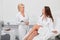 Positive doctor and female client discussing the details of beauty treatment