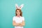 positive easter woman with bunny ears on blue background