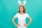 positive easter woman in bunny ears and bow tie on blue background