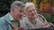 Positive elderly couple making video call using laptop older generation people and modern wireless technology easy use