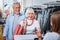 Positive elderly family paying for purchases in shopping store