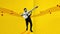 Positive, emotional, artistic african man playing guitar against yellow background. Jazz, rock and roll.Stop motion