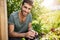 Positive emotions, countryside lifestyle. Outdoor portrait of young bearded hispanic farmer smiling with teeth, working