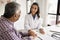 Positive empathetic doctor woman giving support to elderly patient man