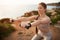 Positive energy young caucasian lady in sportswear doing arm exercise with dumbbells, enjoy training