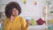 Positive and enthusiastic Beautiful african american woman with an afro hairstyle looking at the Bank card in their