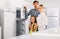 Positive family with child buying refrigerator