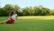 Positive family playing with ball in meadow. Happy man throwing ball to girl