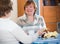 Positive female pensioners drinking coffee and chatting