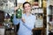 Positive female showing fragile glass item in store