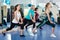 Positive females working out at aerobic class in modern gym