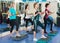 Positive females working out on aerobic step platform