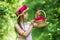 Positive florist holding flowerpot. flower composition. Beautiful girl in straw hat collect roses. happy childhood