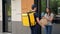 Positive food delivery man courier with thermal backpack deliver order woman