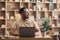 Positive freelance man working on laptop at home, sitting at workplace and looking aside at copy space