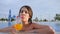 Positive gesture of Young female drinking colored beverage in swimming pool Outdoors