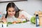 Positive girl arranging shrimps in plate