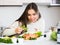 Positive girl arranging shrimps in plate