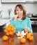 Positive girl eating mandarin in home