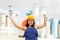 Positive girl in overalls with Japan flag in her hands against the background of chimneys of modern factory