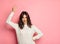 Positive girl showing peace sign on pink background