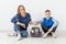 Positive good-looking mother and son launch their beautiful gray Scottish Fold cat into their new apartment after the