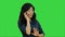 Positive and happy asian woman talking on a cell phone on a Green Screen, Chroma Key