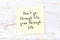 Positive inspiring quote handwritten on sticky note on wooden background