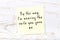 Positive inspiring quote handwritten on sticky note on wooden background