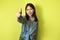 Positive Korean Lady Gesturing Thumbs Up Approving Offer, Yellow Background