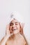 Positive lady enjoys morning spa treatment. Girl after shower posing on isolated background.