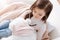 Positive little girl examining fluffy toy with stethoscope