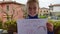 Positive little schoolgirl holds poster with inscription everything will be ok