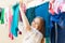 Positive long-haired housewife drying clothes