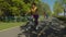 Positive lovely african american woman cycling through public park