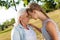 Positive loving woman standing with her granddaughter head to head