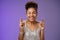 Positive lucky charming african american young girl celebrating birthday making wish in elegant silver dress close eyes