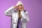 Positive lucky cute blond girl having fun winter vacation in silver glittering jacket hat posing happily smiling white