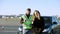 Positive male driving instructor and female student showing thumbs up looking at camera smiling. Portrait of happy young