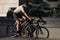 Positive man biking on street during summer time