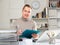 Positive man bookkeeper doing paperwork in office