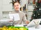 Positive man bookkeeper doing paperwork in office during Christmastime